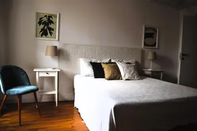 a bedroom with a bed and a blue chair at Apartment Termini in Rome