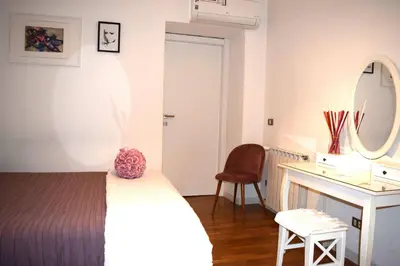 a bedroom with a bed and a desk and a mirror at Apartment Termini in Rome