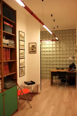 a living room with a desk and a table with a chair at Lo Studio Guest House in Rome