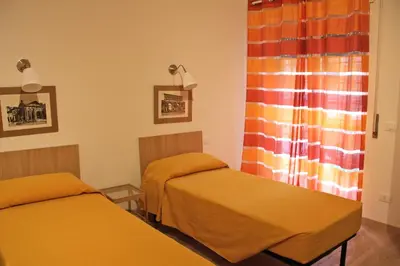 a room with two beds and a window at Lo Studio Guest House in Rome