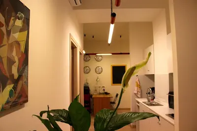 a kitchen with a plant in the middle of a room at Lo Studio Guest House in Rome