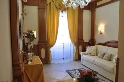 a living room with a couch and a window at Rome Imperial Crown in Rome