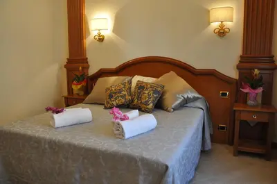 a bedroom with a bed with two pillows on it at Rome Imperial Crown in Rome