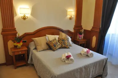 a bedroom with a bed with towels on it at Rome Imperial Crown in Rome