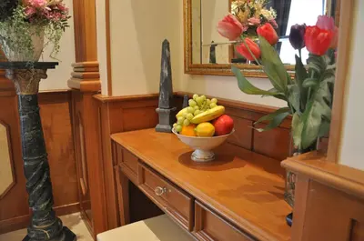 a bowl of fruit on a table with a vase of flowers at Rome Imperial Crown in Rome