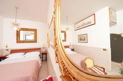a hotel room with two beds and a mirror at Terrazza San Pietro in Rome