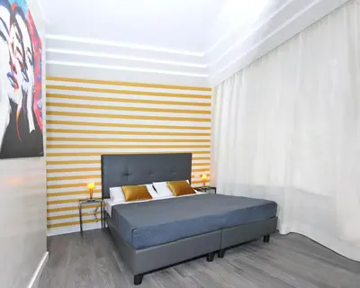 a bedroom with a bed and a striped wall at Il Cavaliere in Rome