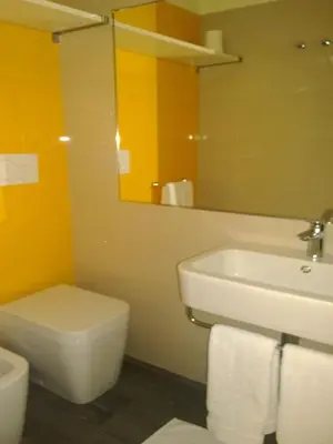 a bathroom with a sink and a toilet and a mirror at Il Cavaliere in Rome