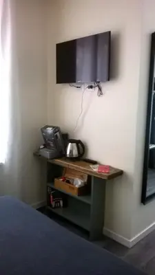 a room with a desk with a television on a wall at Il Cavaliere in Rome