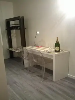 a white table with two chairs and a bottle of wine at Il Cavaliere in Rome