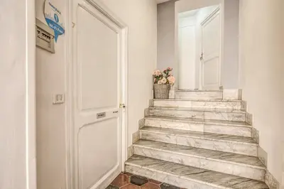 a staircase with a white door and a potted plant at Relais La Torretta in Rome