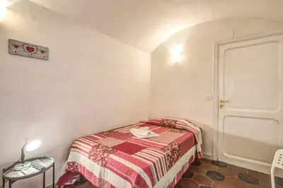 a small bedroom with a bed in a room at Relais La Torretta in Rome