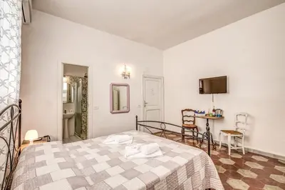 a bedroom with a bed and a table in a room at Relais La Torretta in Rome