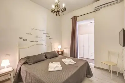 a bedroom with a bed with two towels on it at Relais La Torretta in Rome