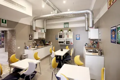 a restaurant with white tables and yellow chairs at NEW GENERATION HOSTEL Rome center in Rome