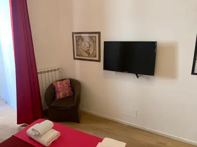 a living room with a flat screen tv on a wall at Trasteverome45 in Rome