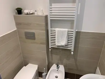 a small bathroom with a toilet and a sink at Trasteverome45 in Rome