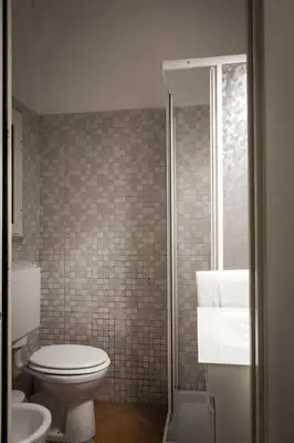 a bathroom with a toilet and a shower and a sink at Trasteverome45 in Rome