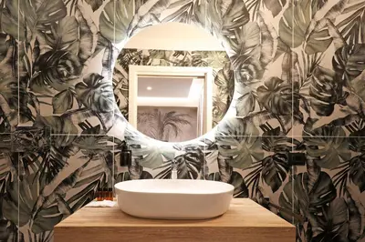 a bathroom with a white sink and a mirror at Grand Tour Rome Suites - Liberty Collection in Rome