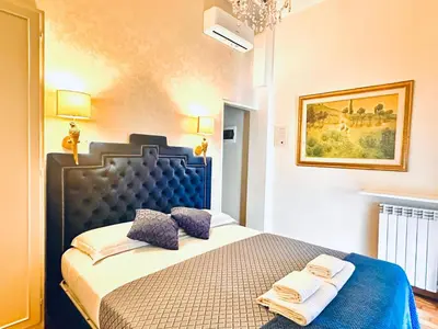 a bedroom with a bed with two pillows on it at Grand Tour Rome Suites - Liberty Collection in Rome