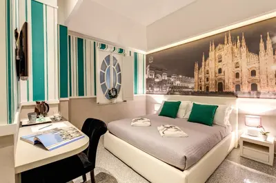 a bedroom with a bed and a desk with a desk at Grand Tour Rome Suites - Liberty Collection in Rome