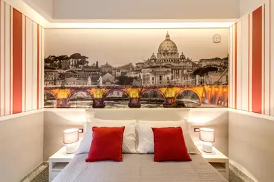 a bedroom with a view of the vatican at Grand Tour Rome Suites - Liberty Collection in Rome