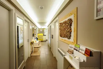 a hallway in a building with a table and a chair at Domus Castroni Pompeo Magno in Rome