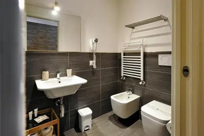 a bathroom with a sink and a toilet at Domus Castroni Pompeo Magno in Rome