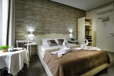 a bedroom with two swans sitting on a bed at Domus Castroni Pompeo Magno in Rome