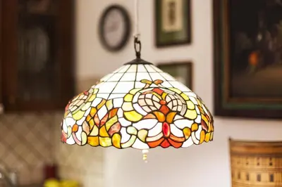 a stained glass light fixture hanging from a wall at TrastEver Holiday in Rome