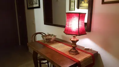 a table with a red lamp on top of it at TrastEver Holiday in Rome