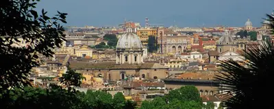 a cityscape of a city with buildings and a cathedral at TrastEver Holiday in Rome