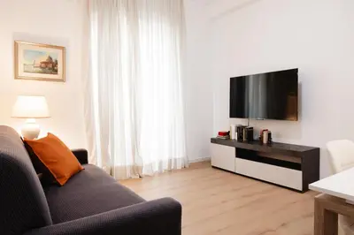 a living room with a couch and a flat screen tv at Dimora Aniene in Rome