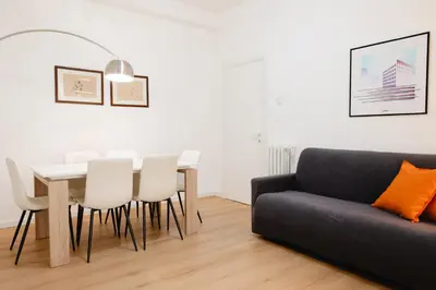 a living room with a couch and a table and chairs at Dimora Aniene in Rome