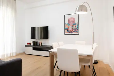 a white dining room with a white table and white chairs at Dimora Aniene in Rome