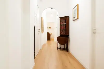 a hallway with white walls and a wooden floor at Dimora Aniene in Rome