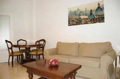 a living room with a couch and a table at Vatican In The Moonlight Apartment in Rome