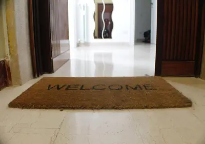 a welcome mat on the floor in front of a door at Vatican In The Moonlight Apartment in Rome