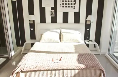 a bedroom with a bed with black and white stripes at Glamroom Luxury Terrace in Rome