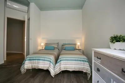 a bed with blue pillows in a bedroom at Cola Di Rienzo A E B in Rome