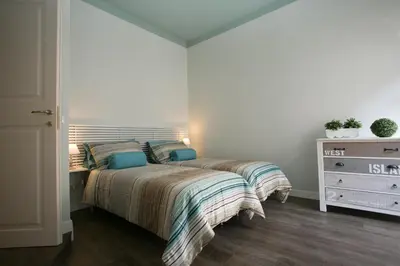 a bedroom with a bed with two pillows and a dresser at Cola Di Rienzo A E B in Rome