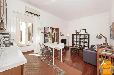 a kitchen and living room with a table and a couch at 4BNB - Vatican Doors Flat in Rome
