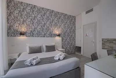 a bedroom with a large bed with towels on it at Vatican Tourist Inn in Rome