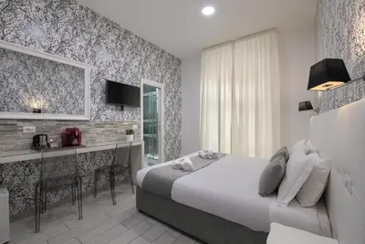 a bedroom with a bed and a desk in a room at Vatican Tourist Inn in Rome