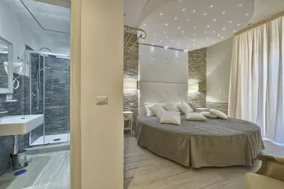 a bedroom with a large bed with white pillows at Vatican Tourist Inn in Rome