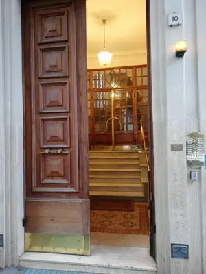 a door leading into a building with a staircase at Landlord in Trastevere in Rome