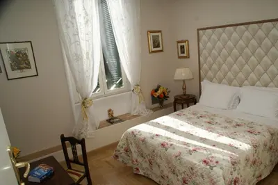a bedroom with a bed and a window at Landlord in Trastevere in Rome