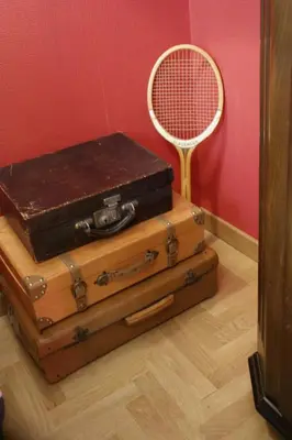 a stack of suitcases next to a tennis racket at Landlord in Trastevere in Rome