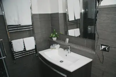 a bathroom with a white sink and a mirror at Landlord in Trastevere in Rome