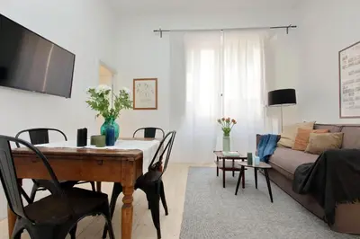 a living room with a table and a couch at Amleto Apartments in Rome